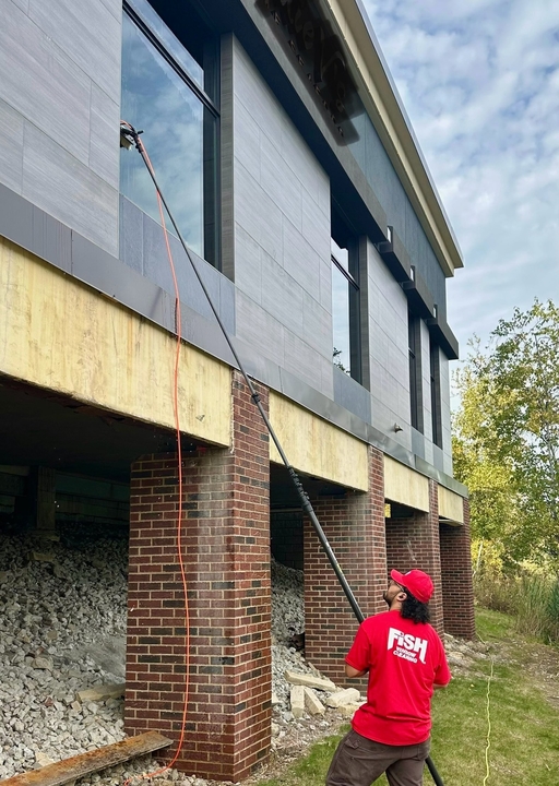 Local FISH technician cleaning windows at a Chicago-area commercial property